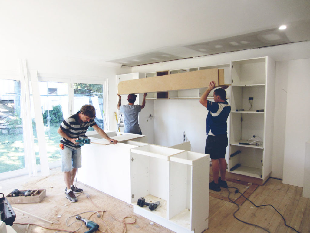 Workers installing a kitchen